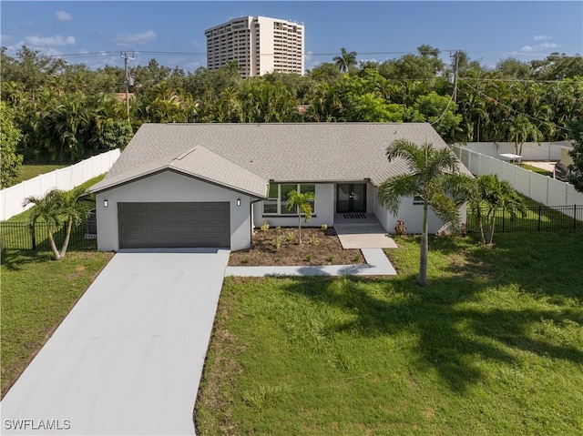 view of front facade with a garage and a front yard