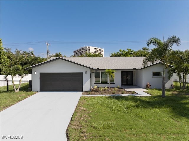 ranch-style home with a garage and a front yard