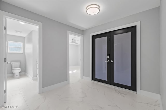 foyer featuring light tile patterned floors and french doors