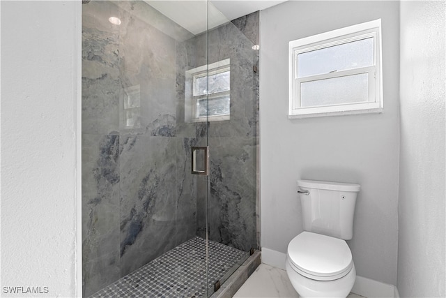 bathroom featuring tile patterned floors, toilet, and a shower with shower door