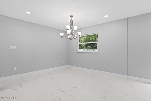 unfurnished room with tile patterned floors and a notable chandelier