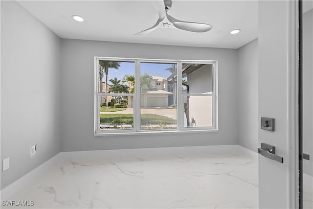 spare room featuring a wealth of natural light and ceiling fan