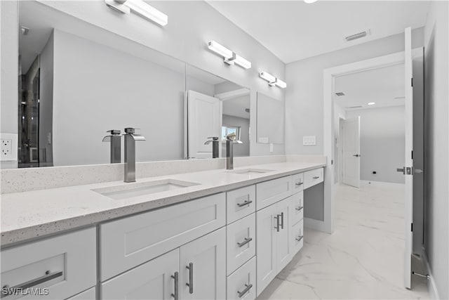 bathroom with tile patterned floors and dual vanity