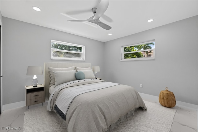 tiled bedroom featuring ceiling fan