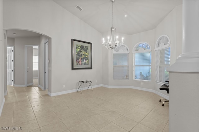 unfurnished dining area with light tile patterned floors, an inviting chandelier, and vaulted ceiling