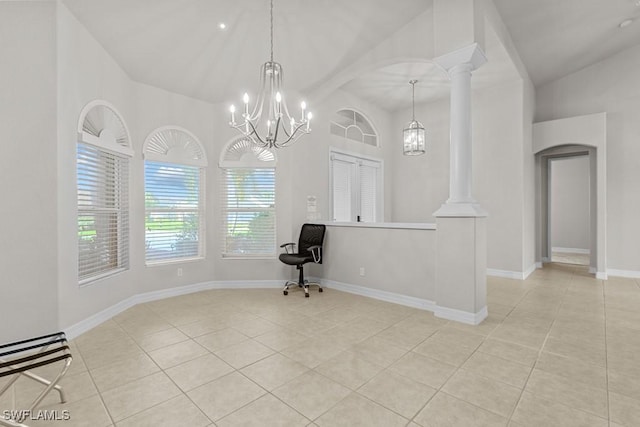 unfurnished room with light tile patterned floors, arched walkways, a chandelier, baseboards, and decorative columns