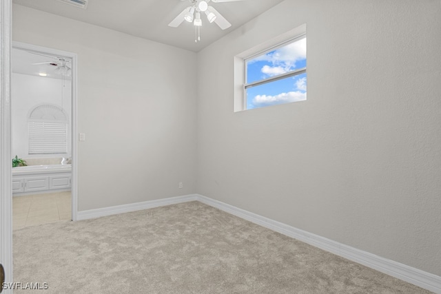 empty room with light colored carpet and ceiling fan