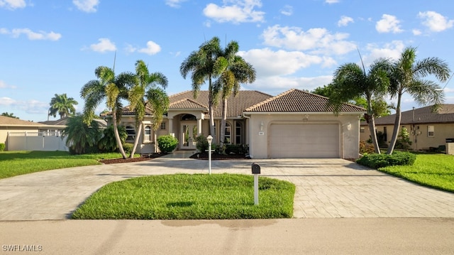 mediterranean / spanish house with a front yard and a garage