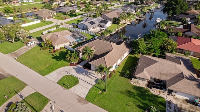 bird's eye view with a water view and a residential view