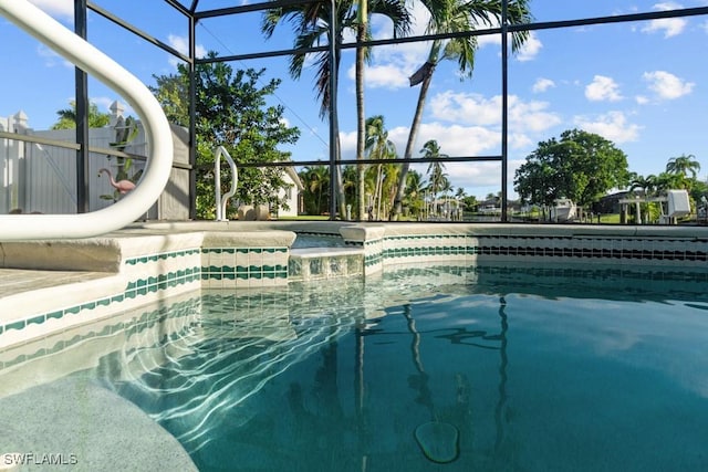 pool with a water slide and glass enclosure