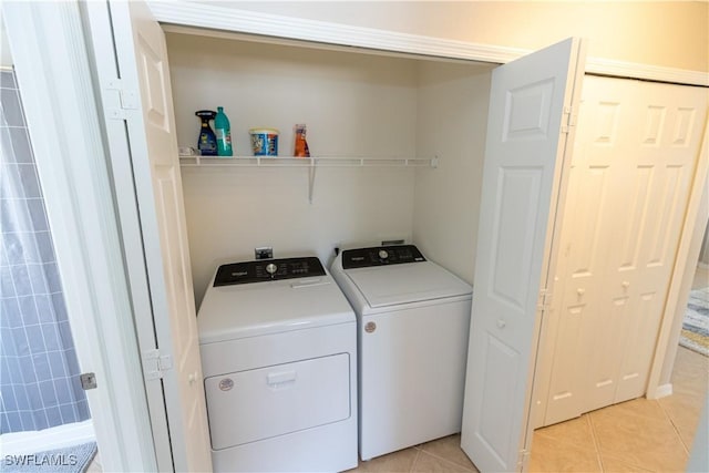 laundry room featuring light tile patterned floors, laundry area, and washer and dryer