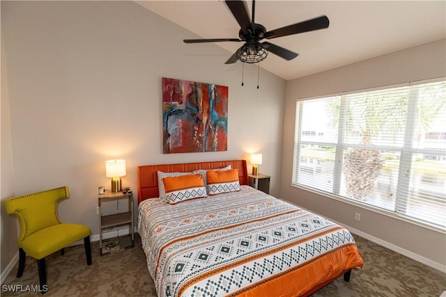 carpeted bedroom with a ceiling fan, vaulted ceiling, and baseboards