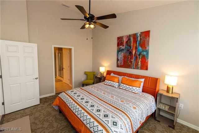 bedroom with a high ceiling, visible vents, ceiling fan, and baseboards