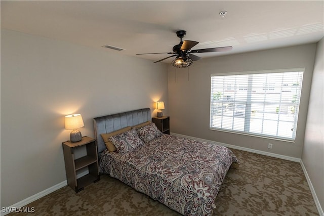 carpeted bedroom with ceiling fan, visible vents, and baseboards