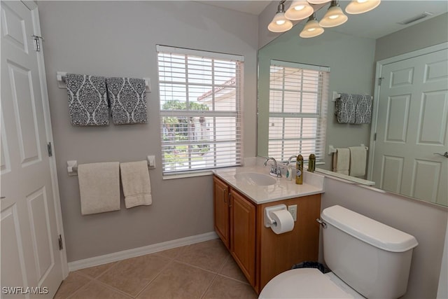 bathroom featuring visible vents, baseboards, toilet, tile patterned flooring, and vanity