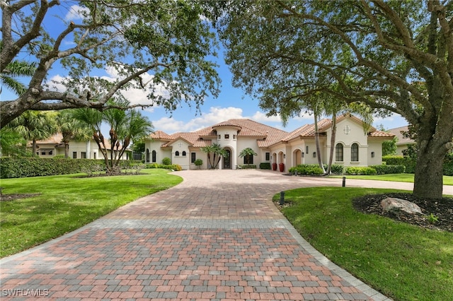 mediterranean / spanish home with a front lawn