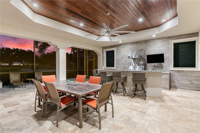 patio terrace at dusk featuring ceiling fan