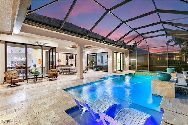 pool at dusk with a lanai, a patio area, ceiling fan, and outdoor lounge area