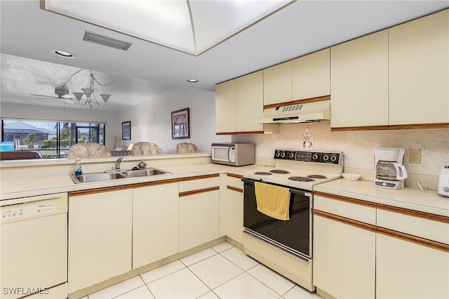 kitchen with white appliances, cream cabinetry, premium range hood, ceiling fan, and sink