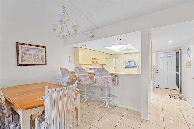 dining area featuring baseboards, recessed lighting, light tile patterned flooring, and a notable chandelier