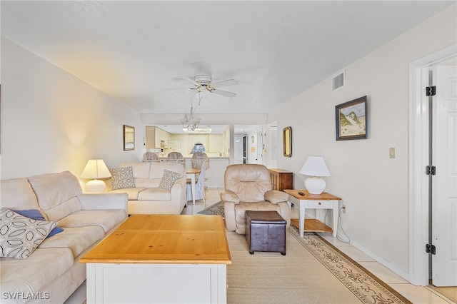 living room featuring ceiling fan and light tile patterned floors