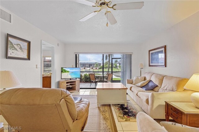 tiled living room with ceiling fan