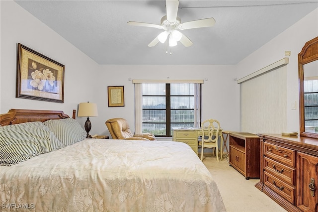 bedroom with ceiling fan and light colored carpet