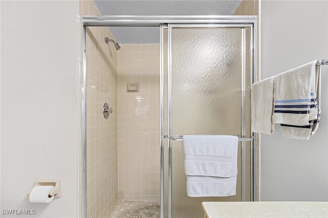 bathroom featuring a shower with door