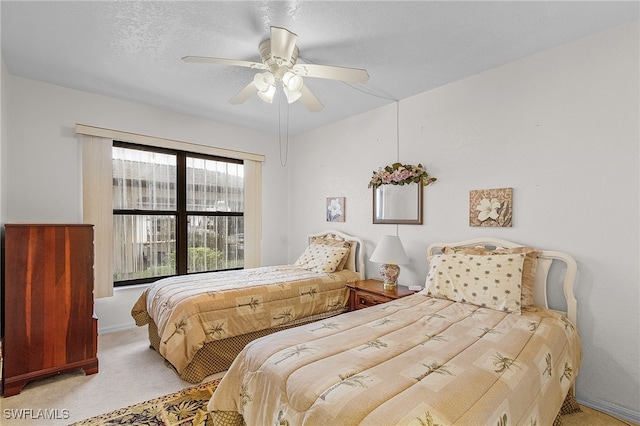 bedroom featuring ceiling fan and light carpet