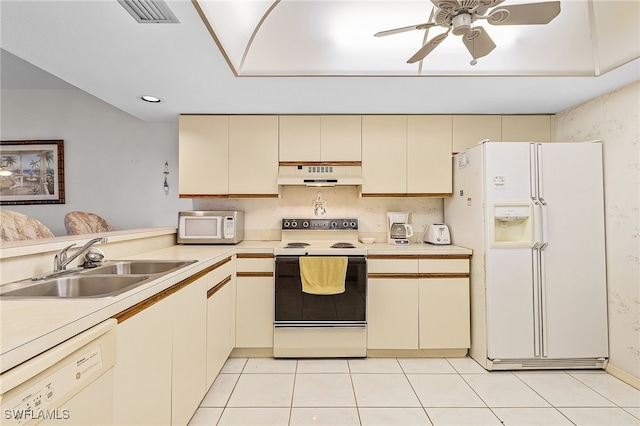 kitchen featuring ceiling fan, white appliances, cream cabinetry, light tile patterned floors, and premium range hood