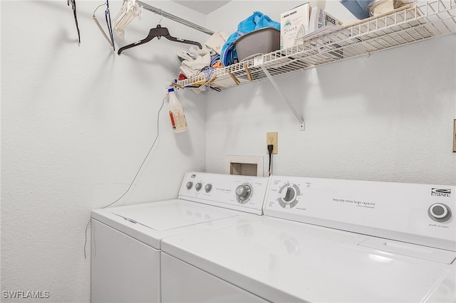 clothes washing area with washing machine and clothes dryer