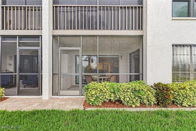 doorway to property with stucco siding