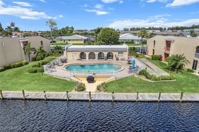 view of swimming pool with a lawn, a water view, and a patio