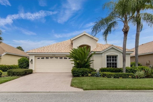 view of front of home with a front lawn and a garage