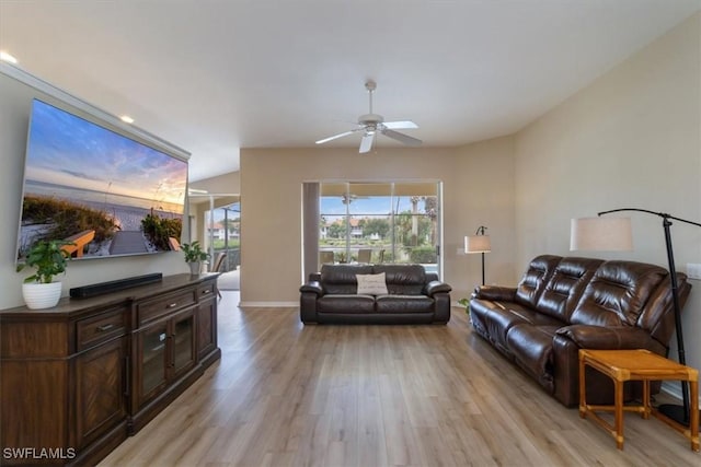 living room featuring light wood-type flooring and ceiling fan