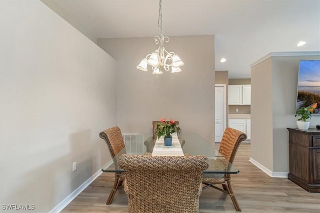 dining room featuring light hardwood / wood-style floors and a chandelier