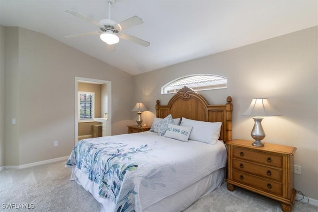 carpeted bedroom featuring ensuite bath, ceiling fan, and vaulted ceiling