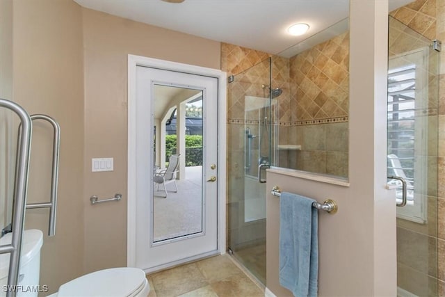 bathroom with toilet and an enclosed shower