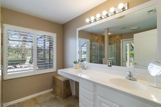 bathroom featuring an enclosed shower, vanity, and plenty of natural light