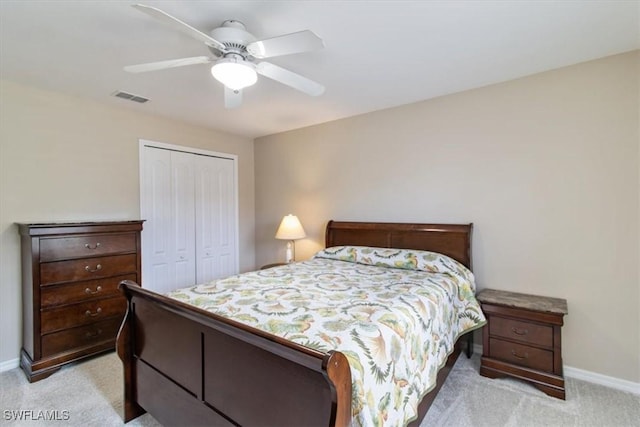 bedroom featuring light carpet, a closet, and ceiling fan