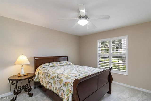 bedroom with ceiling fan and light colored carpet