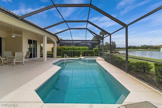 view of swimming pool featuring a patio area, glass enclosure, ceiling fan, an in ground hot tub, and a water view