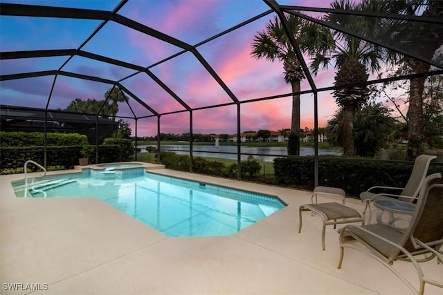 pool at dusk featuring a lanai, a water view, an in ground hot tub, and a patio area