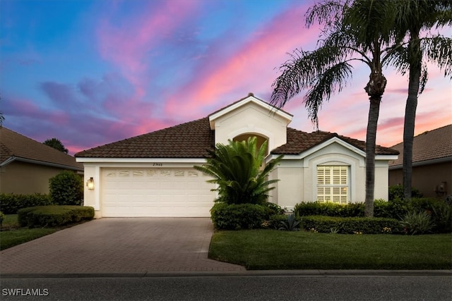 view of front of property featuring a yard and a garage