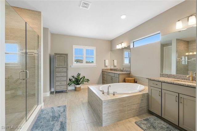 bathroom with vanity, plus walk in shower, and hardwood / wood-style flooring