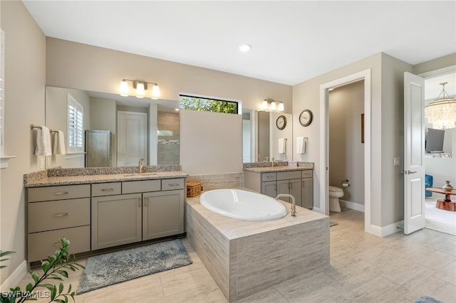 full bathroom featuring tile patterned floors, vanity, toilet, and plenty of natural light