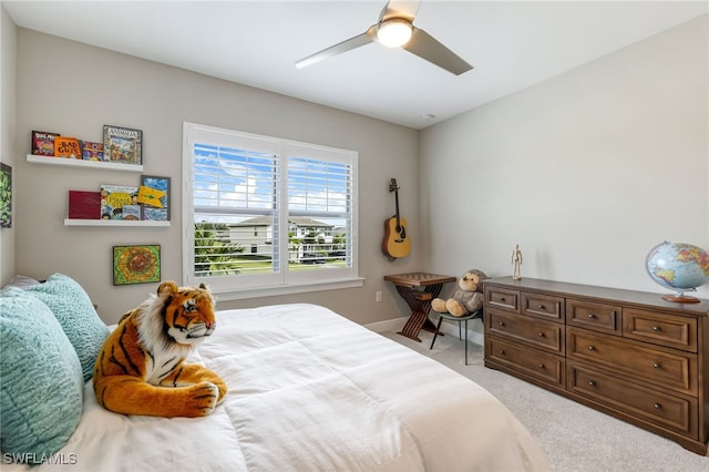 bedroom with ceiling fan and light carpet