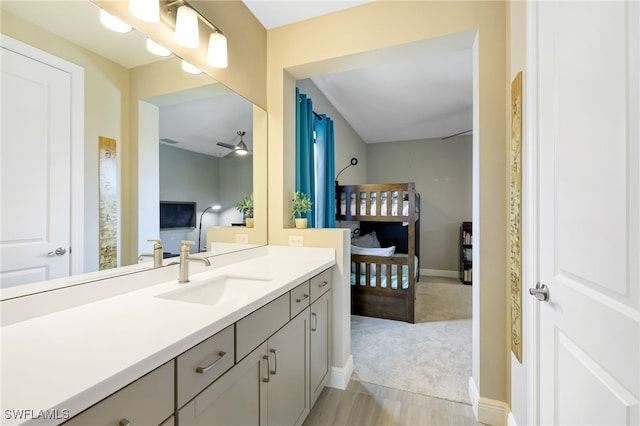 bathroom with ceiling fan and vanity