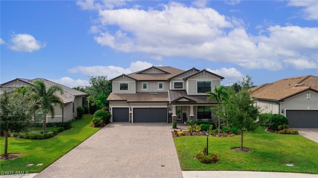 view of front of property with a front yard and a garage