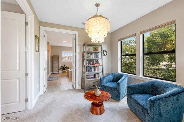 living area with light colored carpet and a chandelier